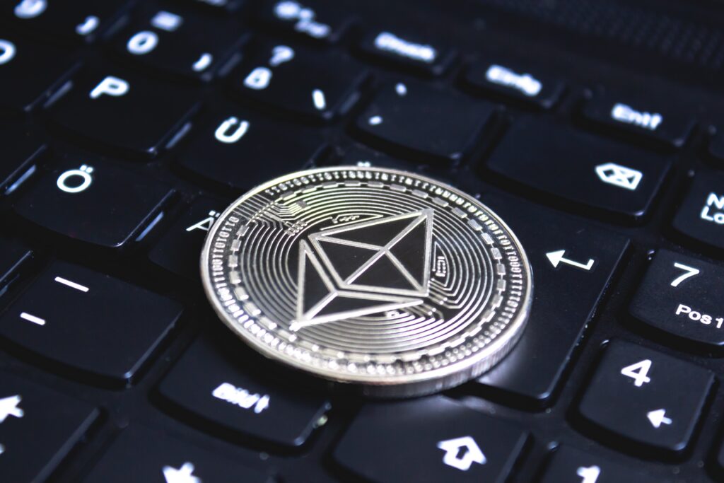 Ethereum coin placed on a black computer keyboard